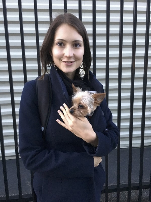 Woman Holding Yorkshire Terrier In Her Jacket For Warmth