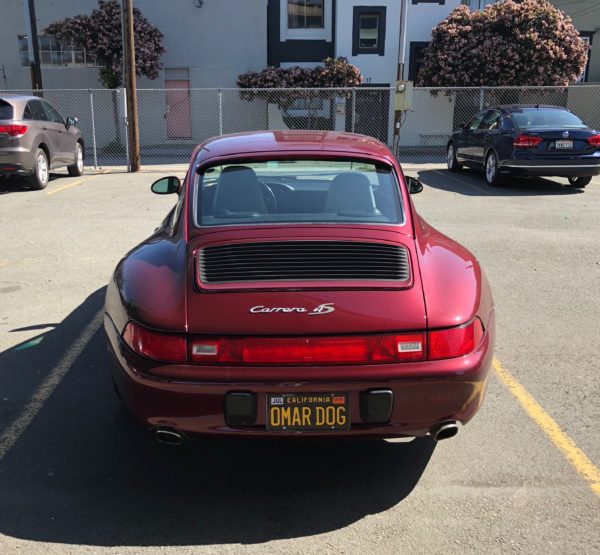 Red Carrera With Omar Dog License Plate