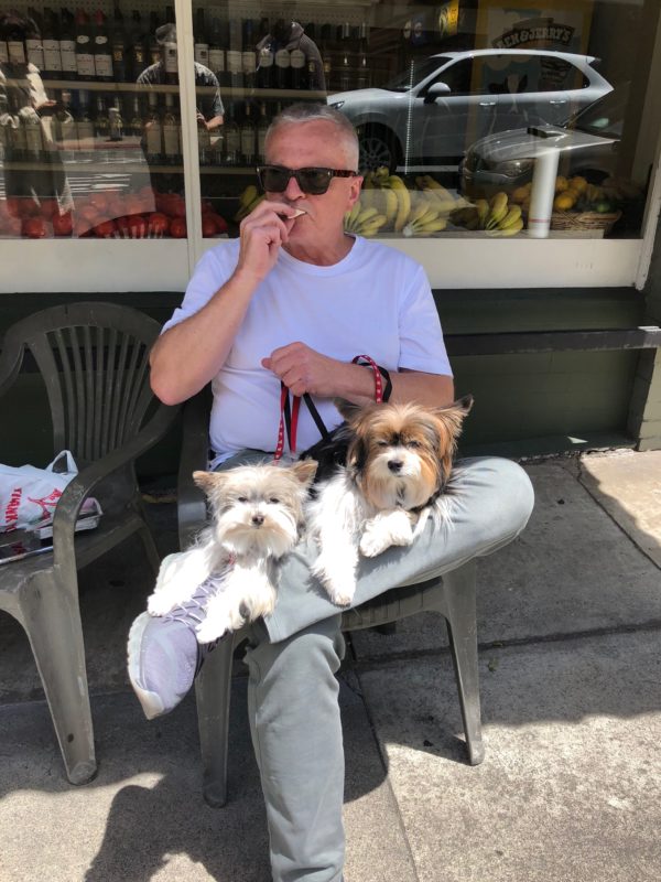 Man With Two Small Dogs In His Lap