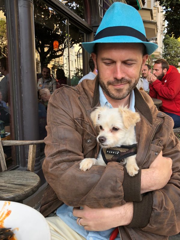 Man With Chihuahua Terrier Mix Cuddled In His Bomber Jacket