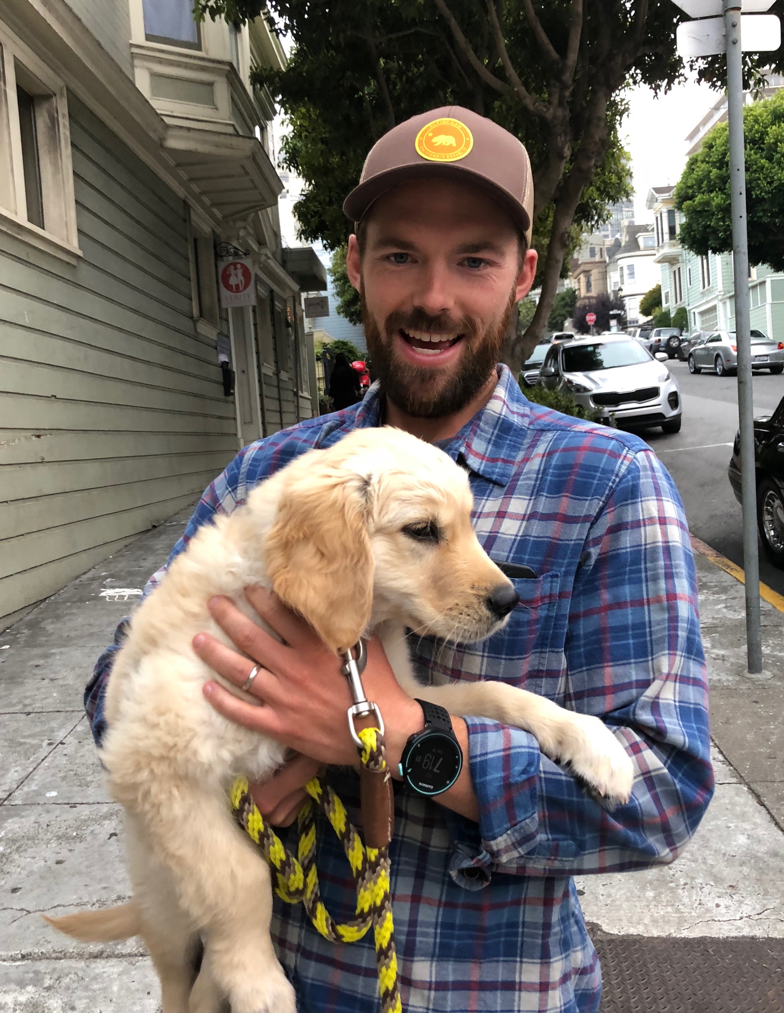 Man Holding Adorable Golden Retriever Puppy