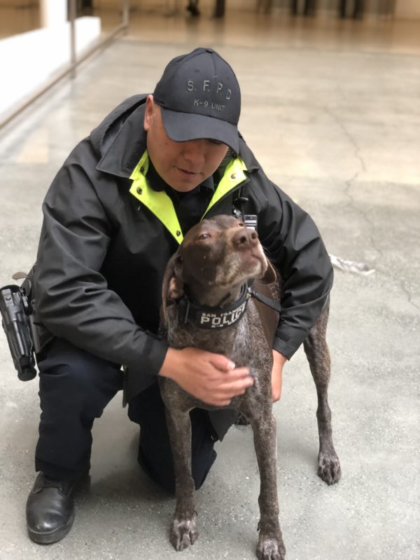 Policeman Hugging Poilce Dog