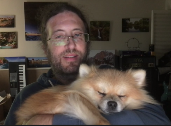Man Holding Sleeping Pomeranian