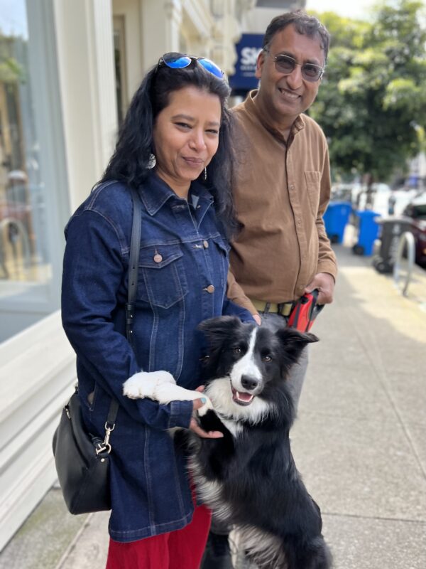 Man And Woman With Happy Border Collie