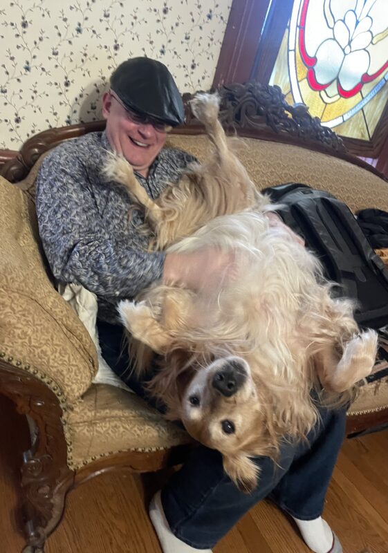 Man With 90-Pound Golden Retriever Lying Belly Up On His Lap