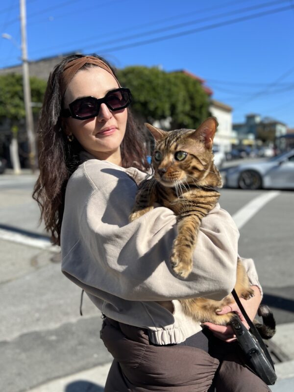 Woman Holding Large Bengal Cat