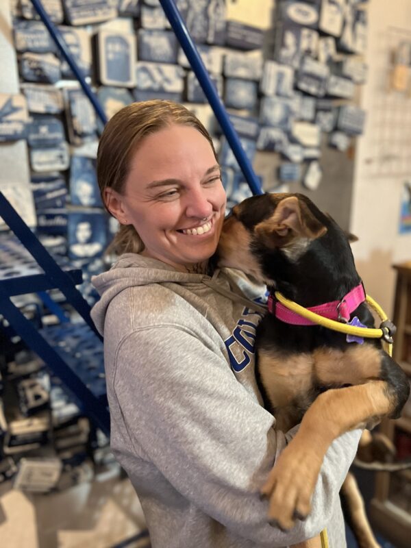 I like YOU! Woman Holding German Shepherd Hound Mix Puppy Who Is Licking Her Neck
