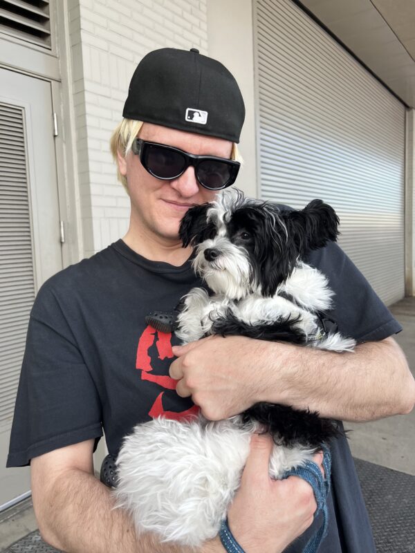 Man Hugging Chinese Crested Dog