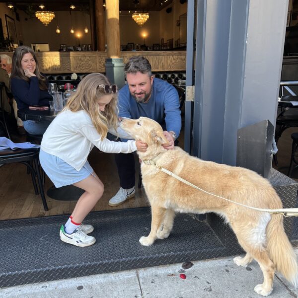 HELLO WILL YOU BE MY NEW BEST FRIENDS? Girl And Man Meeting Golden Retriever Mix Dog At Sidewalk Cafe