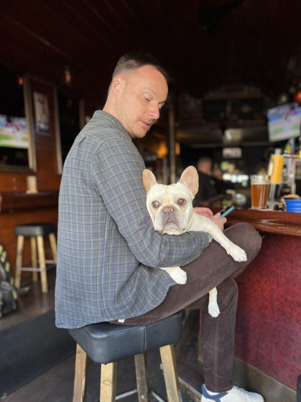 Man At Bar With French Bulldog In His Lap
